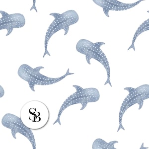 May include: A repeating pattern of light blue whale sharks with white spots on a white background. The whale sharks are in various positions, creating a dynamic design. A circular logo with the letters "SB" is in the lower left.