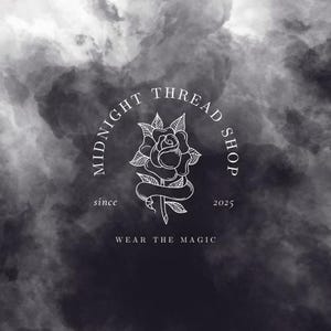 May include: A logo for Midnight Thread Shop, featuring a white rose illustration within a circular frame. The text "MIDNIGHT THREAD SHOP" arches above the rose, with "since 2025" and "WEAR THE MAGIC" below. The background is a dark, cloudy gradient.