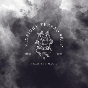 May include: A logo for Midnight Thread Shop, featuring a white rose illustration within a circular frame. The text "MIDNIGHT THREAD SHOP" arches above the rose, with "since 2025" and "WEAR THE MAGIC" below. The background is a dark, cloudy gradient.