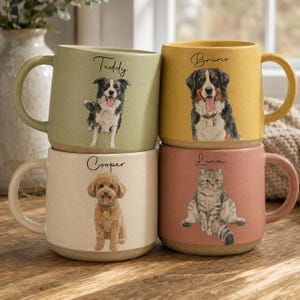 May include: Four ceramic mugs in sage green, mustard yellow, cream, and dusty rose. Each mug features a watercolor-style illustration of a pet and a name printed above: Teddy the dog, Bruno the dog, Cooper the dog, and Luna the cat.