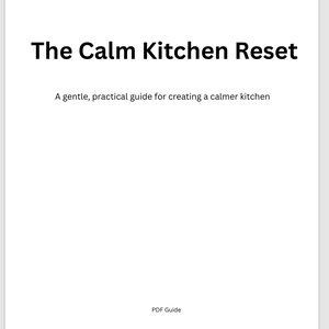 May include: A white PDF guide titled "The Calm Kitchen Reset." The title is in bold black font. Below the title is the text "A gentle, practical guide for creating a calmer kitchen." The words "PDF Guide" are at the bottom.