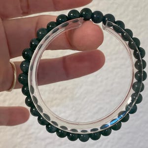 May include: A handmade wooden sign with the text "Welcome to our porch" in white lettering. The sign is rectangular, with a distressed finish, and features a small, decorative heart. It's designed for outdoor use.