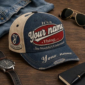 May include: A denim baseball cap with beige side panels, featuring the embroidered text It's a Your name Thing... You Wouldn't Understand on the front, a Y logo on the side, and the words Your name printed on the distressed brim.