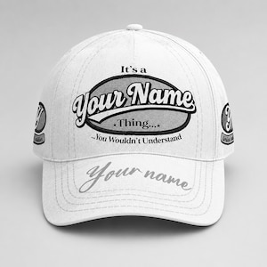 May include: White baseball cap with the text "It's a Your Name Thing... You Wouldn't Understand" in black and gray. The cap also features the text "Your name" on the brim and a logo on the side.