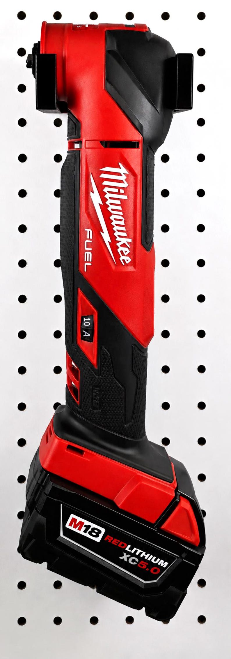 May include: A red and black Milwaukee FUEL cordless right angle drill. The drill is mounted on a white pegboard. The drill has the Milwaukee logo and the text "10 A" and "M18 REDLITHIUM XC5.0" printed on it.