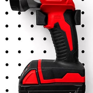 May include: A red and black Milwaukee M18 LED work light and battery pack. The work light has a silver head and the Milwaukee logo. The battery pack is labeled M18 RedLithium XC5.0. The work light is mounted on a white pegboard.