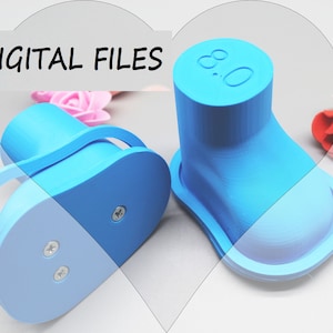 May include: Two light blue 3D-printed shoe forms with a handle and a base, one with the number "8.0" on top. The words "DIGITAL FILES" are in white text above the objects. The background includes pink and red roses.