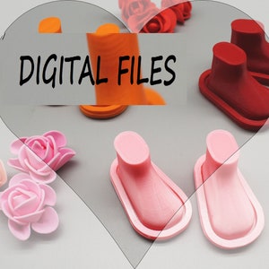 May include: Three pairs of miniature shoes in orange, red and pink. The shoes are 3D printed and have a smooth, rounded finish. The text "DIGITAL FILES" is visible in the image.