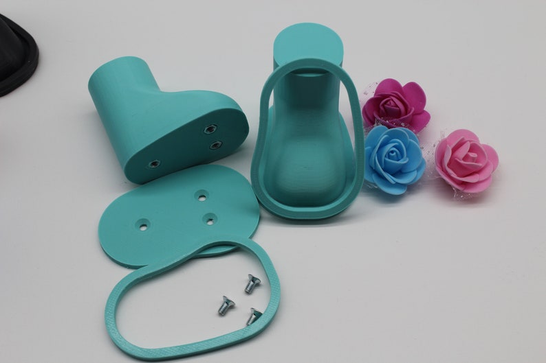 May include: A set of turquoise blue plastic doll shoe molds with three screws. The molds are for a doll's shoe, heel, and sole.