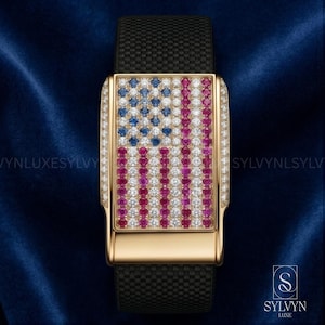 May include: A luxury wristwatch with a gold case and a black fabric strap. The watch face features the American flag design, with blue, white, and red gemstones. The watch is set against a dark blue background.