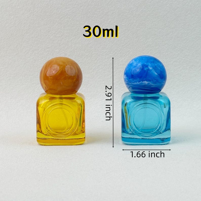 30ml yellow and blue colored glass perfume bottles with marbled caps, labeled dimensions (2.91 inch height, 1.66 inch width) on neutral background.