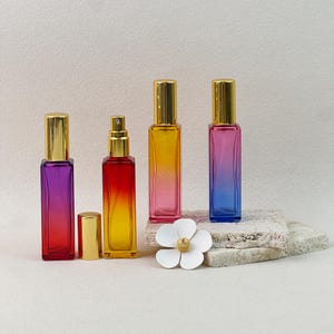 Purple-Red, Red-Yellow, Yellow-Pink, and Pink-Blue gradient perfume bottles, styled with natural stone and flower props.
