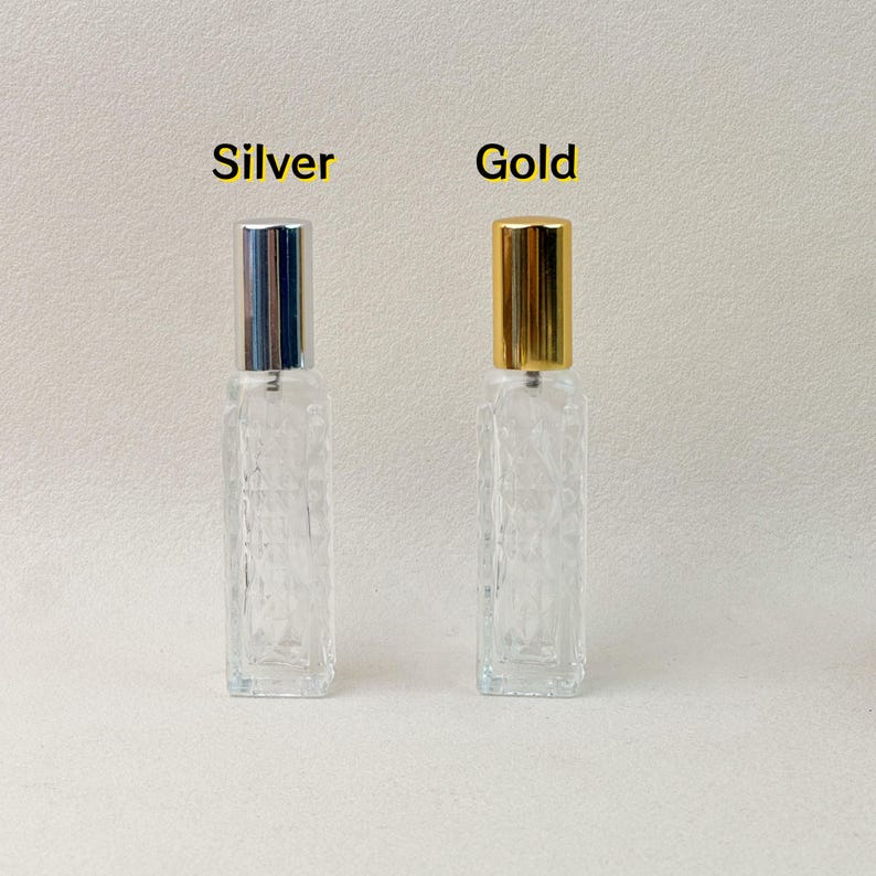 Silver and gold cap 12ml clear diamond-cut glass perfume atomizer bottles, side-by-side view.
