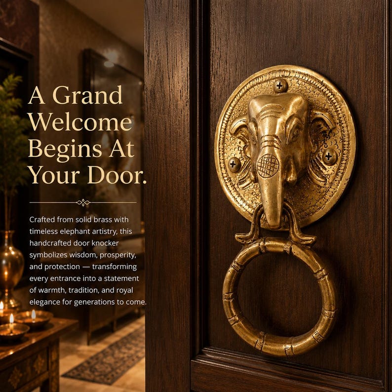 May include: A brass elephant door knocker with a ring handle, mounted on a dark wood door. The knocker features the text "A Grand Welcome Begins At Your Door."