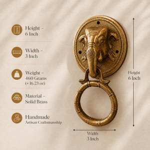 May include: A solid brass door knocker featuring an elephant head design. The handmade knocker is 6 inches in height and 3 inches in width. It weighs 16.23 oz. The knocker has a ring for pulling and is an example of artisan craftsmanship.