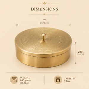 May include: A round brass container with a lid featuring an intricate engraved pattern and a central knob. The container measures 7 inches in diameter and 2.8 inches in height, with a weight of 28.22 ounces and a capacity of 7 bowls.