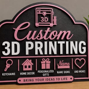 May include: A black arched sign with pink and white raised lettering and icons. It features a 3D printer graphic, the text "Custom 3D PRINTING", and icons for keychains, home decor, gifts, name signs, and hearts, with "BRING YOUR IDEAS TO LIFE".