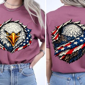 May include: Mauve t-shirt with a detailed graphic of an American bald eagle and a patriotic design. The eagle's head is in the centre, with the American flag design around it. The back of the shirt also features the eagle and flag design.