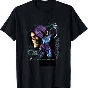 May include: A black t-shirt featuring a graphic of a hooded skeletal figure with a purple cowl, blue armor, and a staff. Green lightning bolts surround the figure. The text HE HAS A SKULL FOR A FACE is printed in green at the bottom of the graphic.