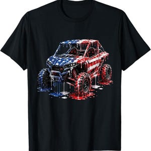 May include: A black short-sleeve t-shirt featuring a graphic of an off-road vehicle with a dripping American flag paint effect. The vehicle is rendered in red, white, and blue, with stars on the front and stripes on the side, appearing to melt onto the ground below.