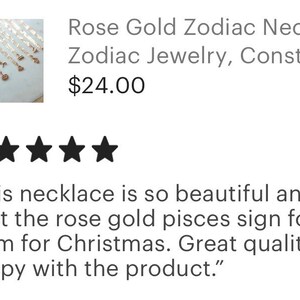 May include: A close-up of a rose gold zodiac necklace with a constellation design. The necklace is displayed on a white surface. "This necklace is so beautiful and dainty! I got the rose gold pisces sign for my mom for Christmas. Great quality, super happy with the product."