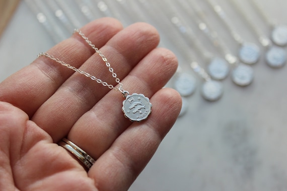 Silver zodiac coin on sale necklace
