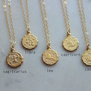 May include: Gold necklaces with zodiac sign pendants. The signs are Sagittarius, Libra, Leo, Capricorn, Cancer and Taurus.