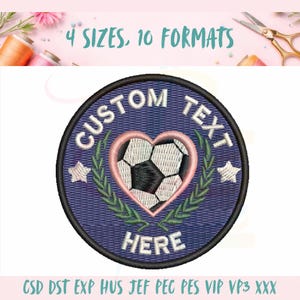 May include: A circular embroidered patch featuring a central heart containing a black and white soccer ball graphic. The patch has a dark blue background with green laurel leaves, two white stars, and the text CUSTOM TEXT HERE in white.