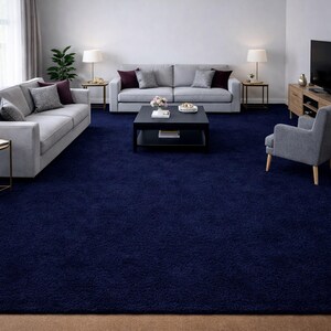 May include: A navy blue shag rug covers the floor of a living room. Two gray sofas with decorative pillows face each other, with a black coffee table in the center. Two lamps sit on side tables, and a gray armchair is in the corner.