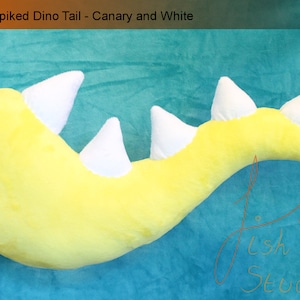 A luxury spiked dinosaur tail perfect for even the most evil of dinosaur princesses.

This is made with soft plush fabric, in canary yellow with five white 3D spikes handsewn along the top