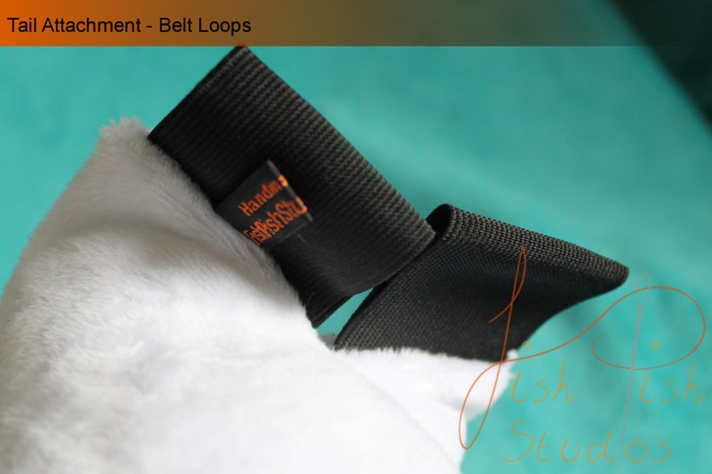 An example of the belt loops used for this tail. As they are made with elastic they fit most belts, or they can be pinned. 

Pins and belts not included.