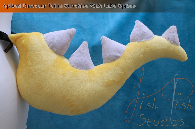 A luxury spiked dinosaur tail perfect for even the most evil of dinosaur princesses.

This is made with soft plush fabric, in sunshine yellow with five latte 3D spikes handsewn along the top