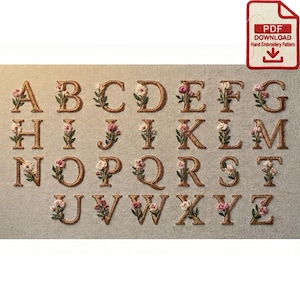 May include: Embroidered alphabet letters A through Z, each adorned with floral accents in pink, white, and green. The letters are in a serif font and are stitched in a golden-brown thread on a neutral fabric background. A PDF download icon is in the upper right corner.