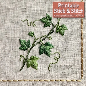 Op de afbeelding: Een handborduurpatroon op lichtbeige stof met een groene klimoprank met gedetailleerde bladeren en krullende ranken. Een rechthoekig oranje label in de rechterbovenhoek toont de witte tekst: Printable Stick & Stitch HAND EMBROIDERY PATTERN.