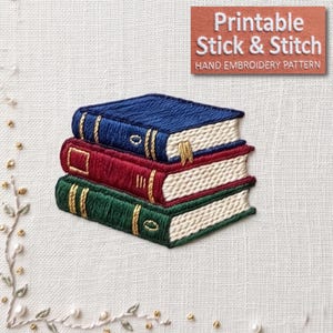 May include: An embroidery design featuring a stack of three books with blue, red, and green covers. Each book has gold-colored spine details and white pages. The text 'Printable Stick & Stitch HAND EMBROIDERY PATTERN' is visible in the top corner.