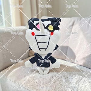 May include: A plush toy character with a white body, black hair, and a black jacket. The character has a large, toothy grin, a pink nose, and red and yellow accents. The text "Tiny Talls" is repeated across the image.