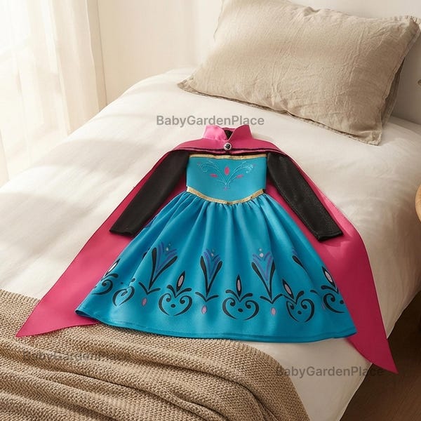 May include: A bright blue dress with long black sleeves and a vibrant pink cape attached at the collar. The bodice features a decorative teal and pink floral pattern, while the skirt displays a repeating dark blue and pink floral motif.