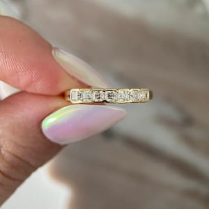 May include: A white ceramic mug with a black handle and the text "But First, Coffee" in a bold, black font. The mug is sitting on a wooden surface. The mug is approximately 4 inches tall.