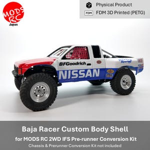 May include: A white, red, and blue Baja racer custom body shell for a remote control truck. The side features the text NISSAN and BFGoodrich. It includes a red window net, silver wheels, and black off-road tyres. The body is FDM 3D printed PETG.