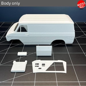May include: A white 3D printed model van body shell with a ribbed roof and open window frames. Included are several separate white plastic components, including a flat rectangular piece, a small block, and a frame with text reading HEAD TAIL SIDE.