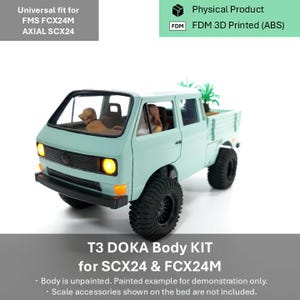May include: A light green T3 DOKA body kit for FMS FCX24M and Axial SCX24 remote control vehicles. The 3D printed ABS model features a truck bed, black tyres, and illuminated yellow headlights. Inside the cabin are two small figures and a dog.