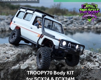 May include: A white TROOPY70 body kit for RC vehicles, compatible with FMS FCX24M and Axial SCX24 with 155mm wheelbase. The FDM 3D printed ABS plastic model features a snorkel, roof rack, and front bumper, shown painted with decals.