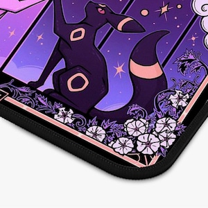 May include: A black and purple mousepad featuring a stylized illustration of a dark creature with pink accents, set against a starry purple background. The design includes white floral elements and a black border.