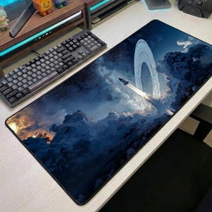 May include: A white ceramic mug with a black handle and the text "But First, Coffee" in a black, bold font. The mug is on a white surface.