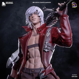 May include: A detailed figurine of a character with white hair, blue eyes, and a red jacket. The figure is holding a large sword and has a muscular physique. The jacket has silver accents and a zipper. The figure is sculpted by Alex Gray.