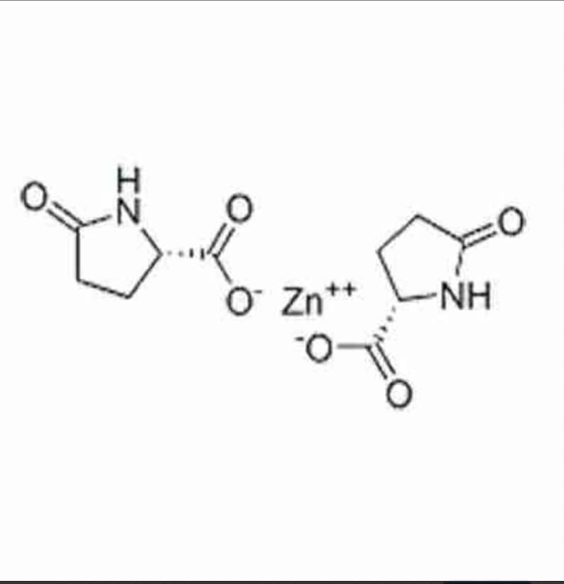May include: A black and white chemical structure diagram of zinc pyrrolidone carboxylate, featuring two pyrrolidone carboxylic acid molecules flanking a central zinc ion labeled Zn++, with clear bonds, oxygen, nitrogen, and hydrogen atoms.