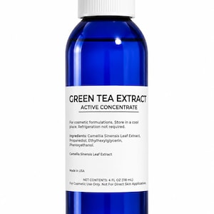 May include: A cobalt blue glass bottle with a white screw-top cap, featuring a white label that reads GREEN TEA EXTRACT ACTIVE CONCENTRATE, listing ingredients and net contents of 4 FL OZ (118 mL) for cosmetic use only, not for direct skin application.