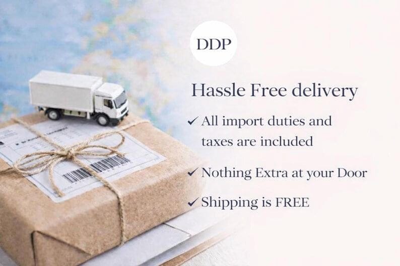 May include: A small white toy delivery truck sits atop a brown cardboard parcel tied with twine. The text reads: DDP, Hassle Free delivery, All import duties and taxes are included, Nothing Extra at your Door, and Shipping is FREE.