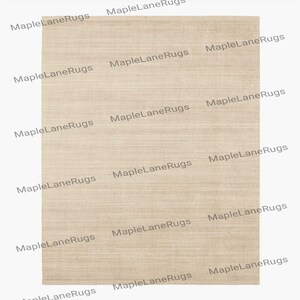 May include: A rectangular beige rug with a horizontal striped pattern. The rug has a neutral color and a simple design, suitable for various interior styles. The text "MapleLaneRugs" is repeated across the image.