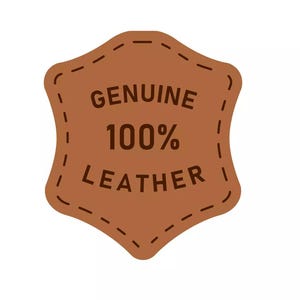 May include: A brown leather tag with the words "GENUINE 100% LEATHER" in dark brown text. The tag has a stitched border and a unique shape, suggesting a product made of genuine leather.